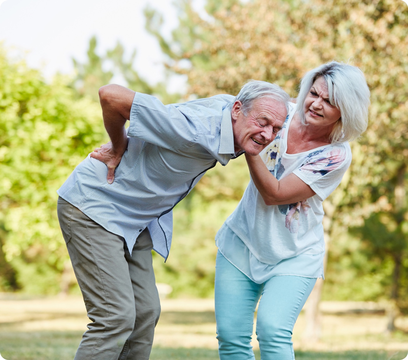 Older adults supporting one another outdoors