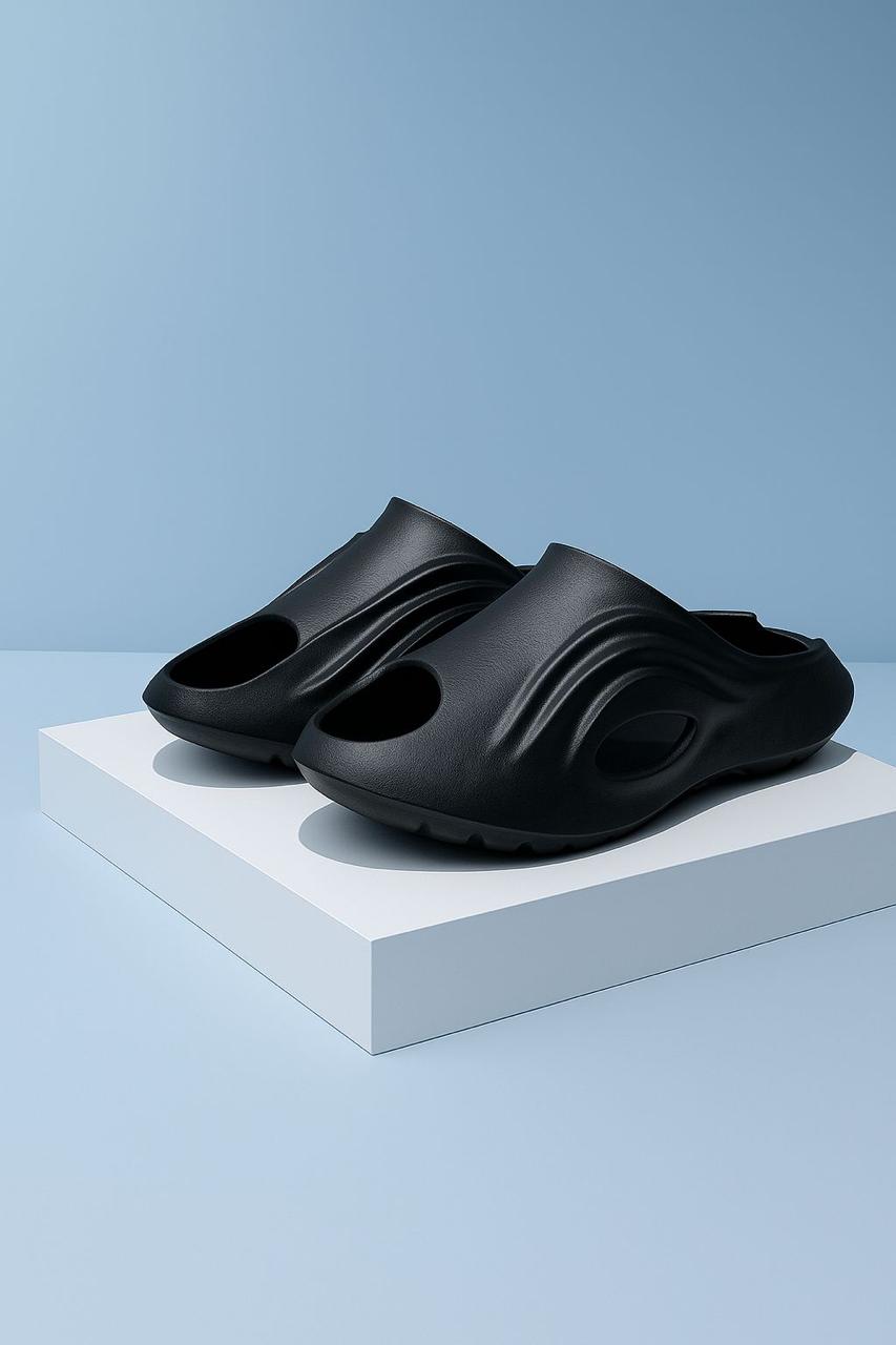 Pair of black I-Revive recovery slides displayed on a pedestal